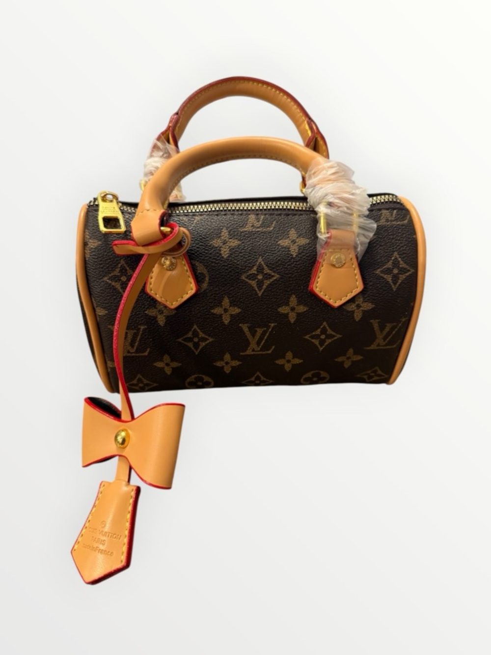 NWOTSource Unknown Brown Monogram Mini Bag with Tan Trim and Red-Edged Bow Charm
